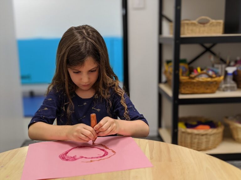 Child working on grasp and hand strength during a one-on-one occupational therapy session in Irvine