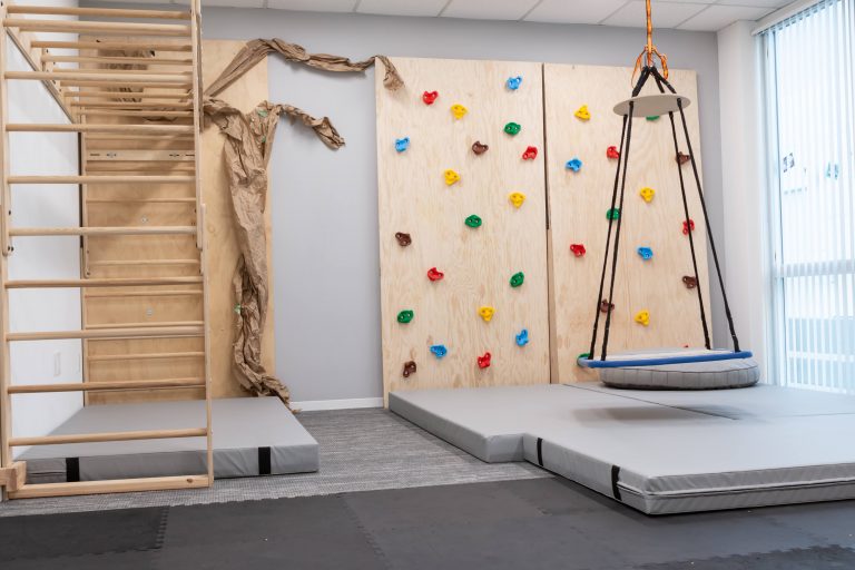 Occupational therapist working with a child on sensory motor skills, the same approach used in partner classrooms