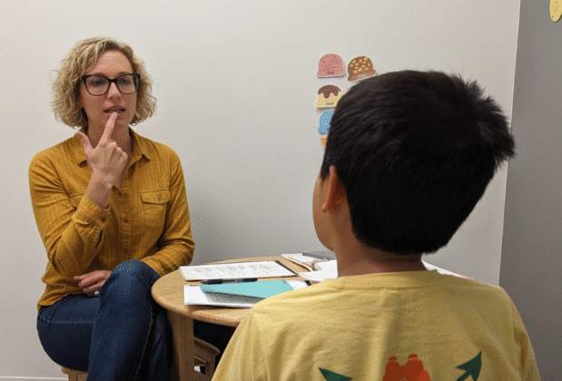 Speech-language pathologist working one-on-one with a child