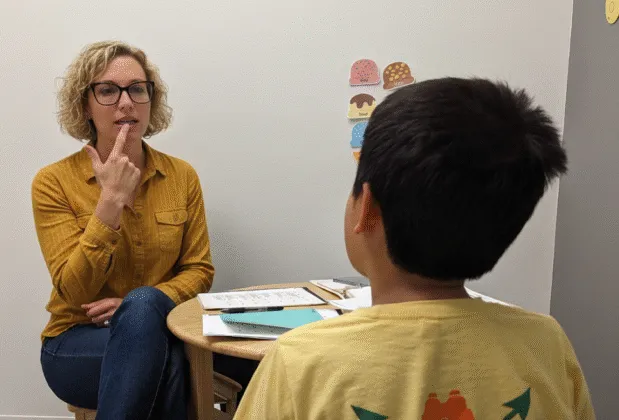 Speech-language pathologist working one-on-one with a child